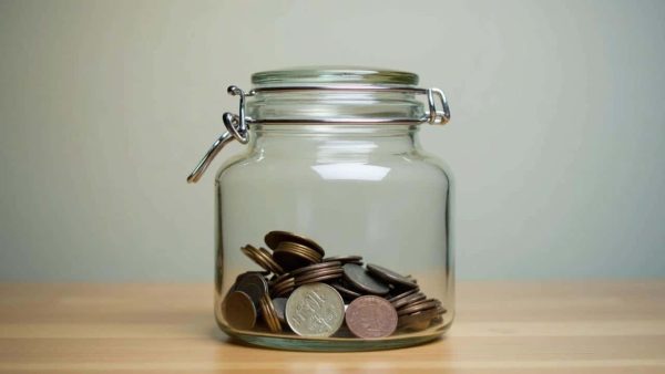 The real world benefit of assigning a specific, unusual container for holding daily loose change as a mental savings trigger